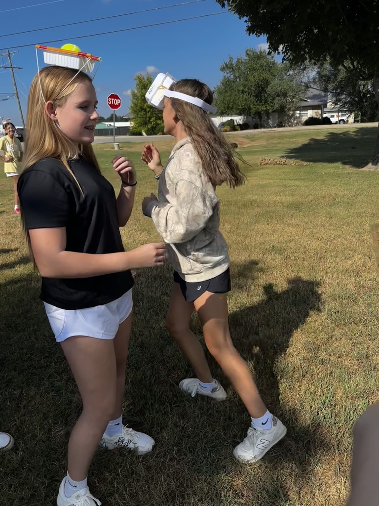 kids with engineered hats to hold tennis balls