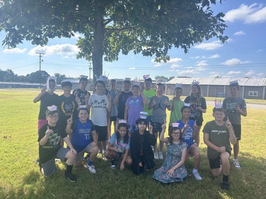 kids with engineered hats to hold tennis balls