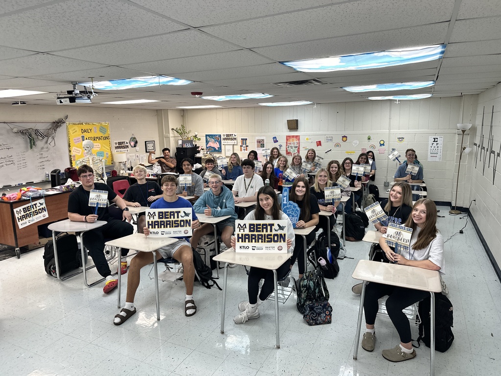 kids holding school spirit signs