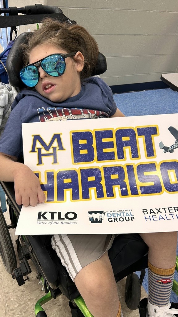 kid holding sign that says beat harrison