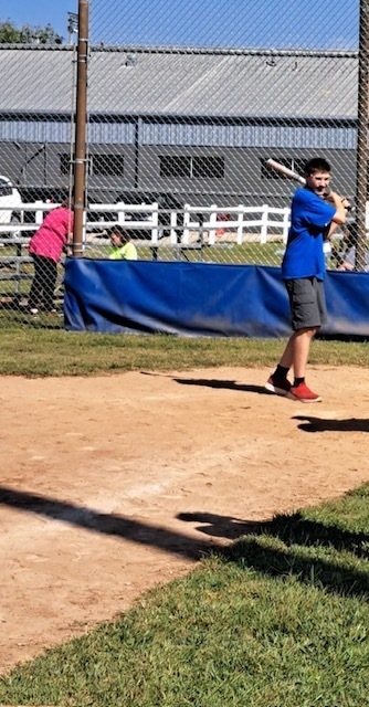 kid hitting baseball