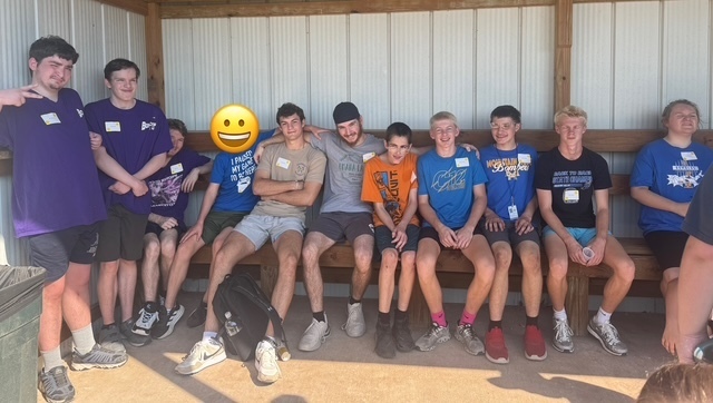 kids posing together in dugout
