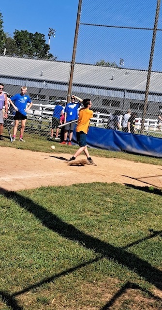 kid hitting baseball