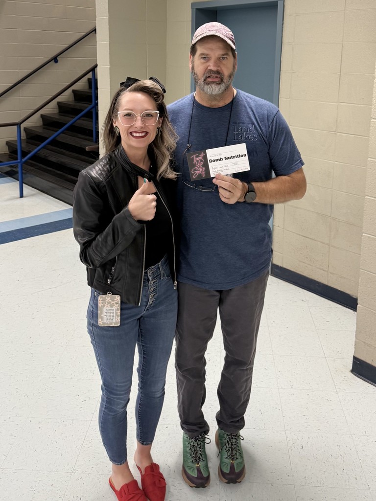 teacher holding gift certificate