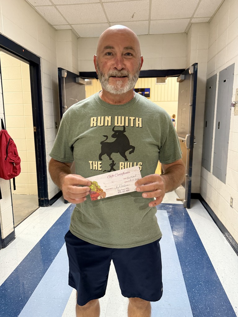 teacher holding gift certificate