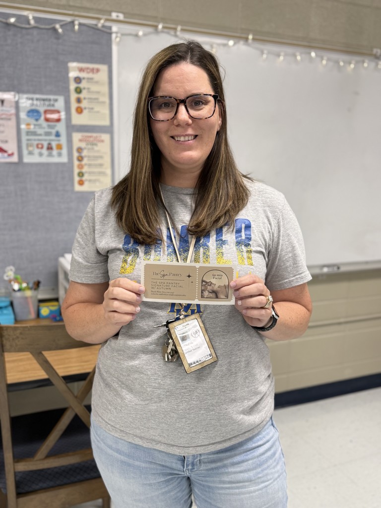 teacher holding gift certificate