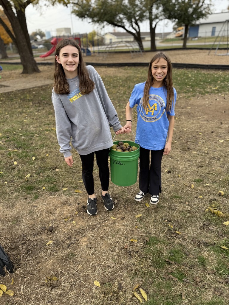 middle school girls carrying bucket