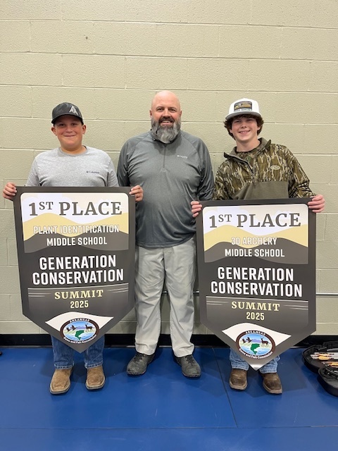 two boys with their teacher and their 1st place banners