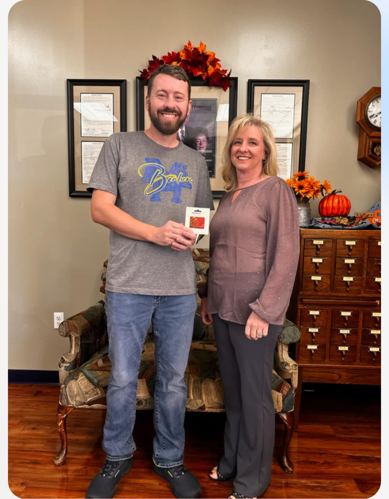 School counselor and Kiwanis representative with gift card in hand