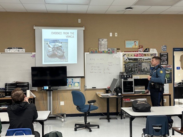 Cop presenting to students