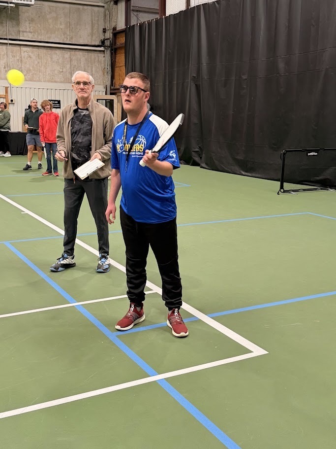 kid playing pickleball