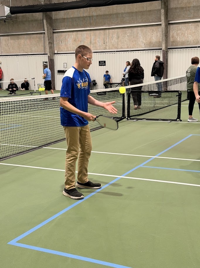 kid playing pickleball