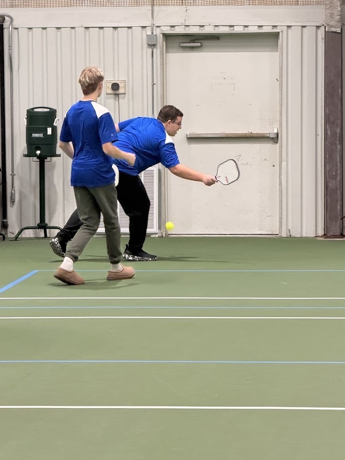 kid playing pickleball