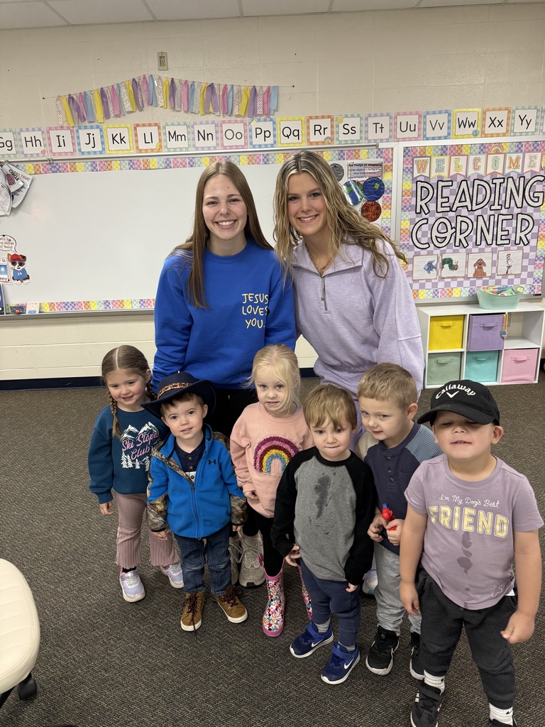 Two teen girls with a group of 6 Pre-K kids