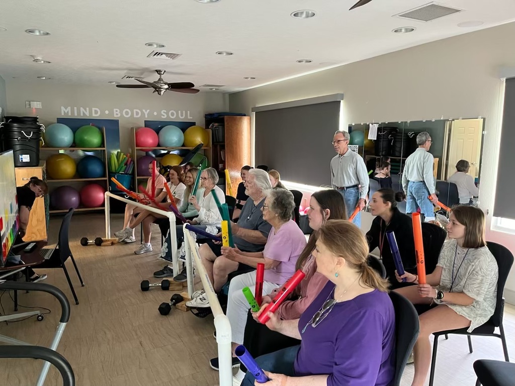 Students playing a game with senior living residents. 