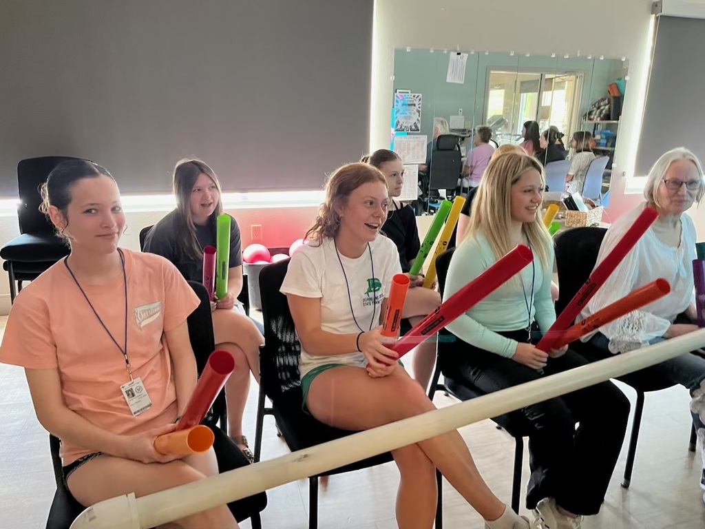 Students playing a game with senior living residents. 