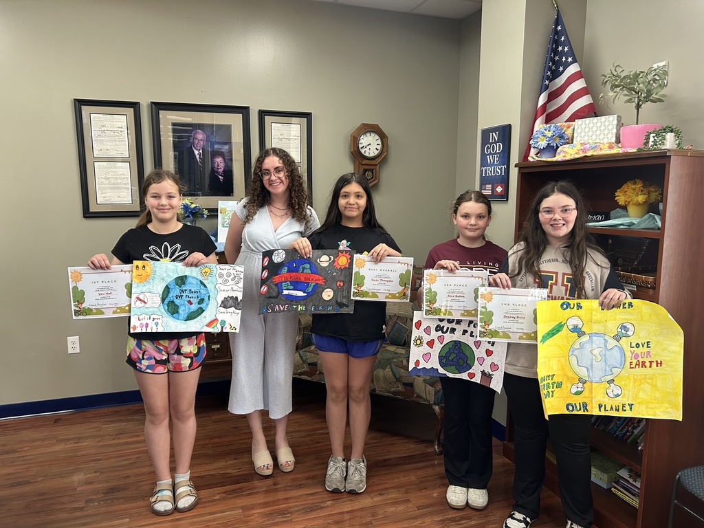 4 students with their posters and certificates from winning the Baxter County Conservation Poster contest
