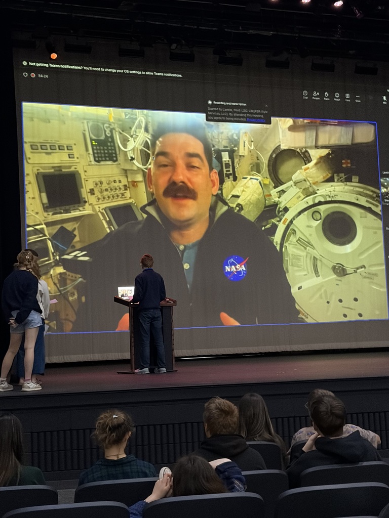 Student asking NASA Astronaut Jack Hathaway a question during the Q&A