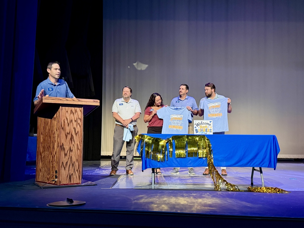 Arvest Bank presenting district staff shirts