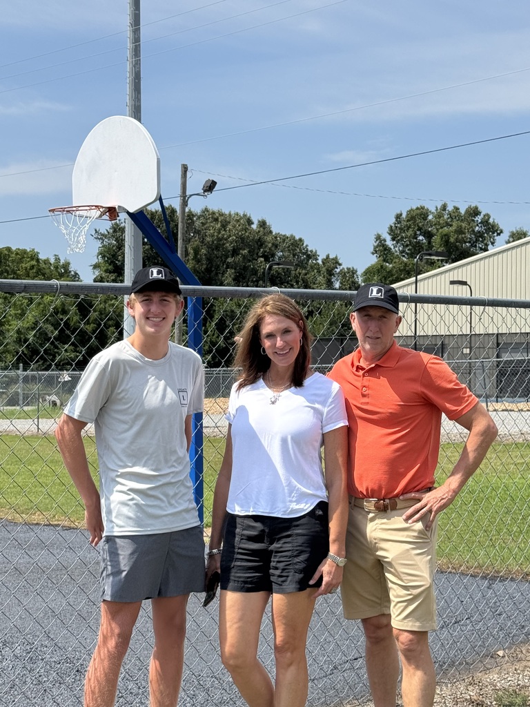 Chris and Kelly Nosari, along with a former MHPS student at the freshly resurfaced basketball courts