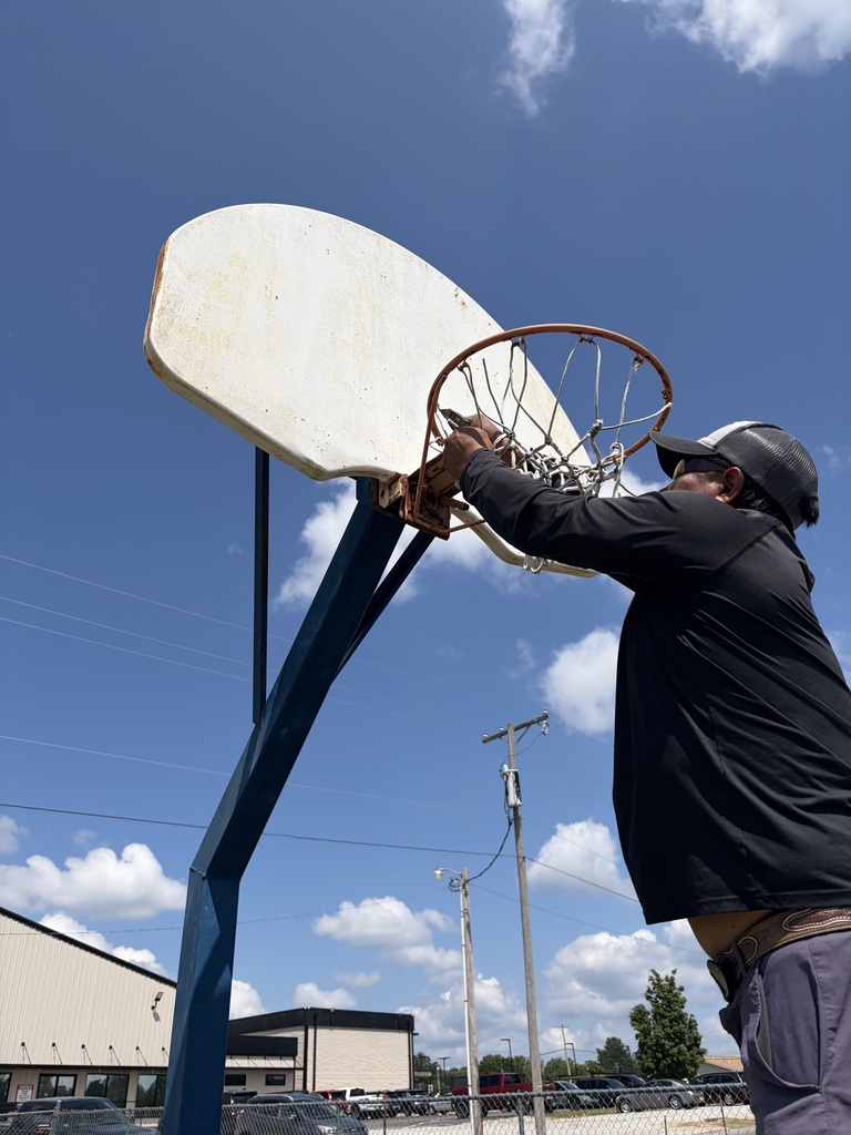 Horton Asphalt installing a new basketball net at Nelson Wilks