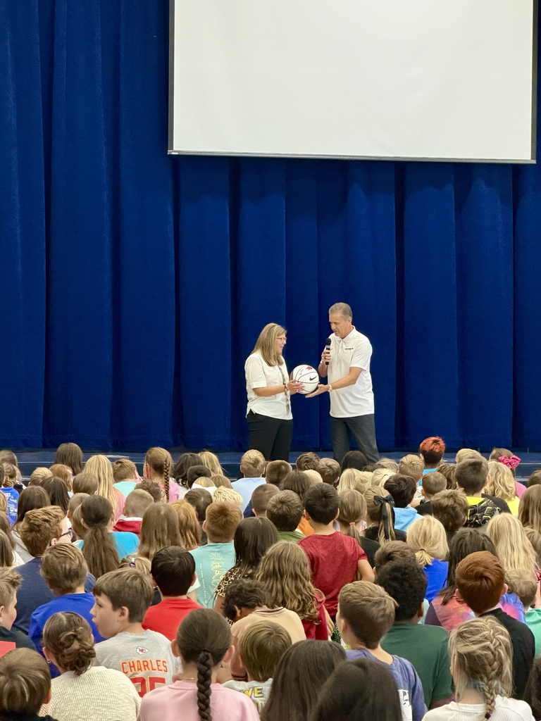 Coach Calipari giving Mrs. Goodwin (Hackler principal) a signed Razorback Basketball