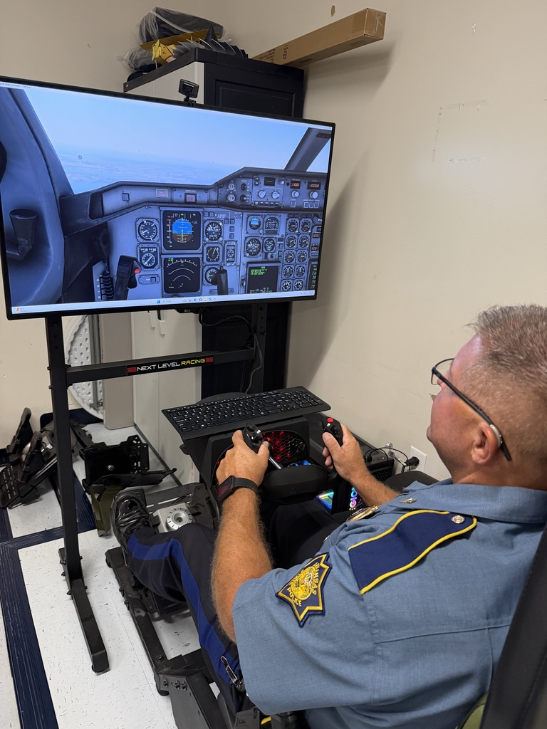 Sgt. Stinnett using the flight simulators in the criminal justice classroom