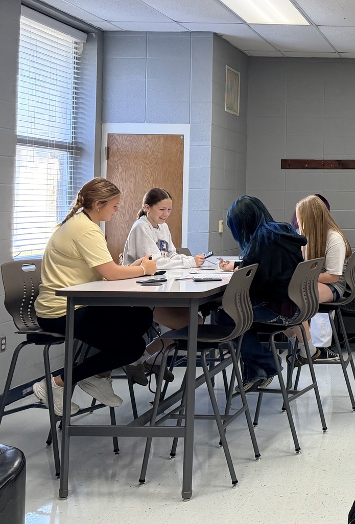 4 female students working on math work at their table