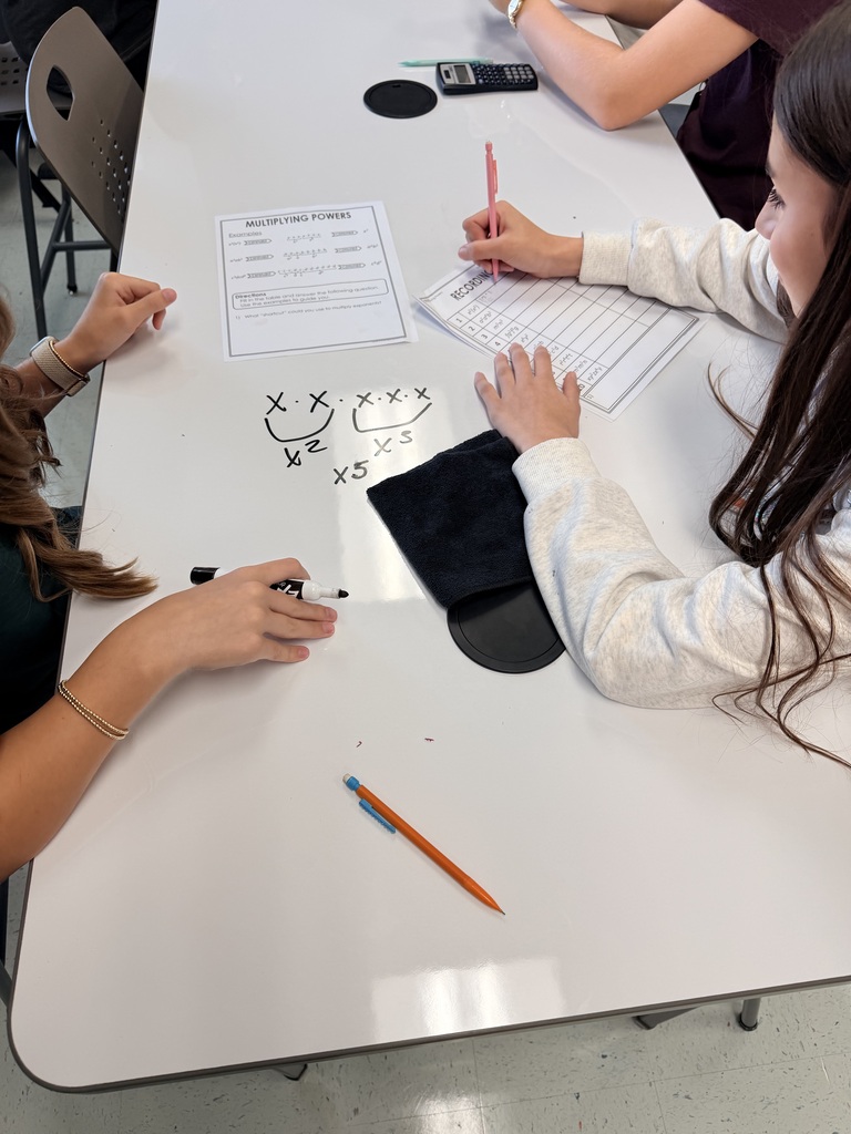 2 students working on math at a table