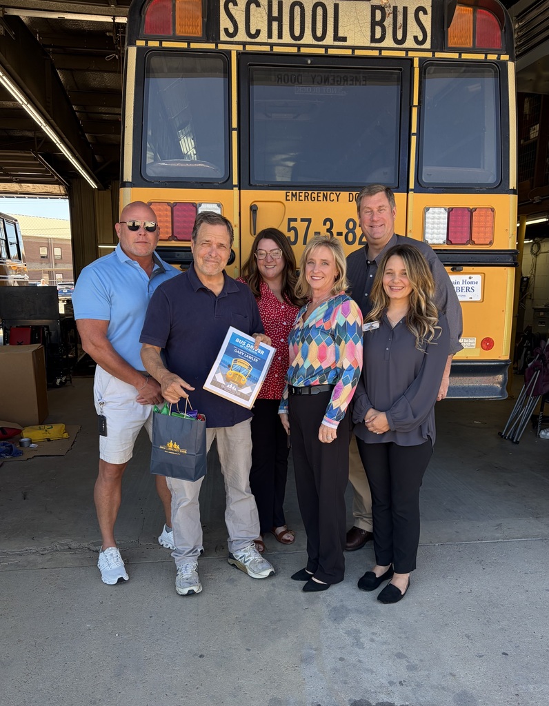 Bus Driver Gary Lawler & First community bank members in front of a bus