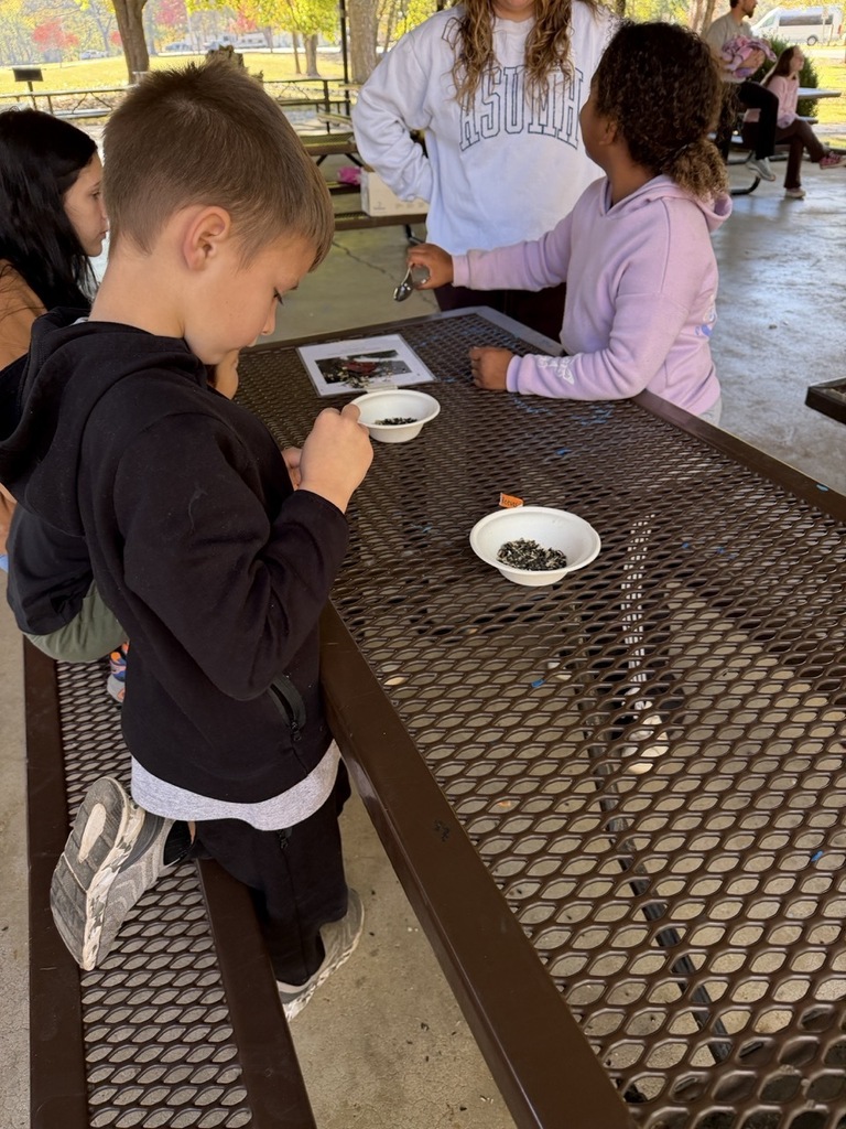 male and female student sitting at a picnic table