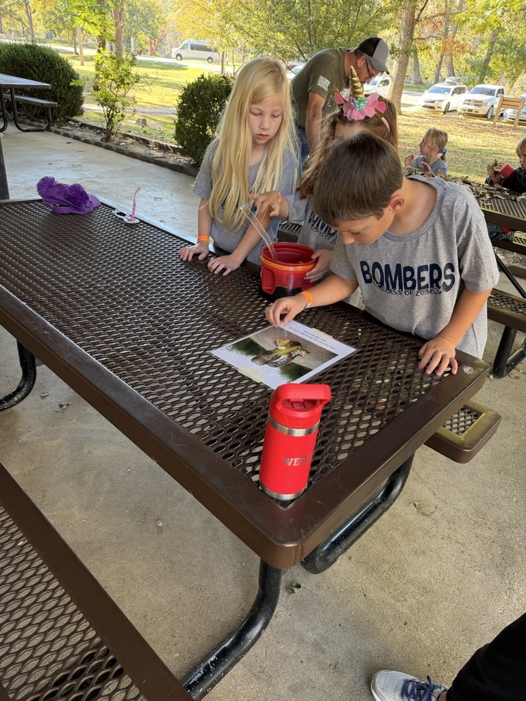 male and female student sitting at a picnic table
