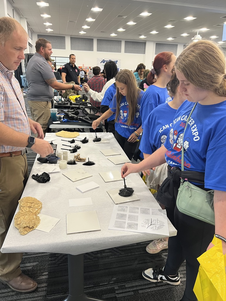 8th grader learning how to dust for fingerprints.