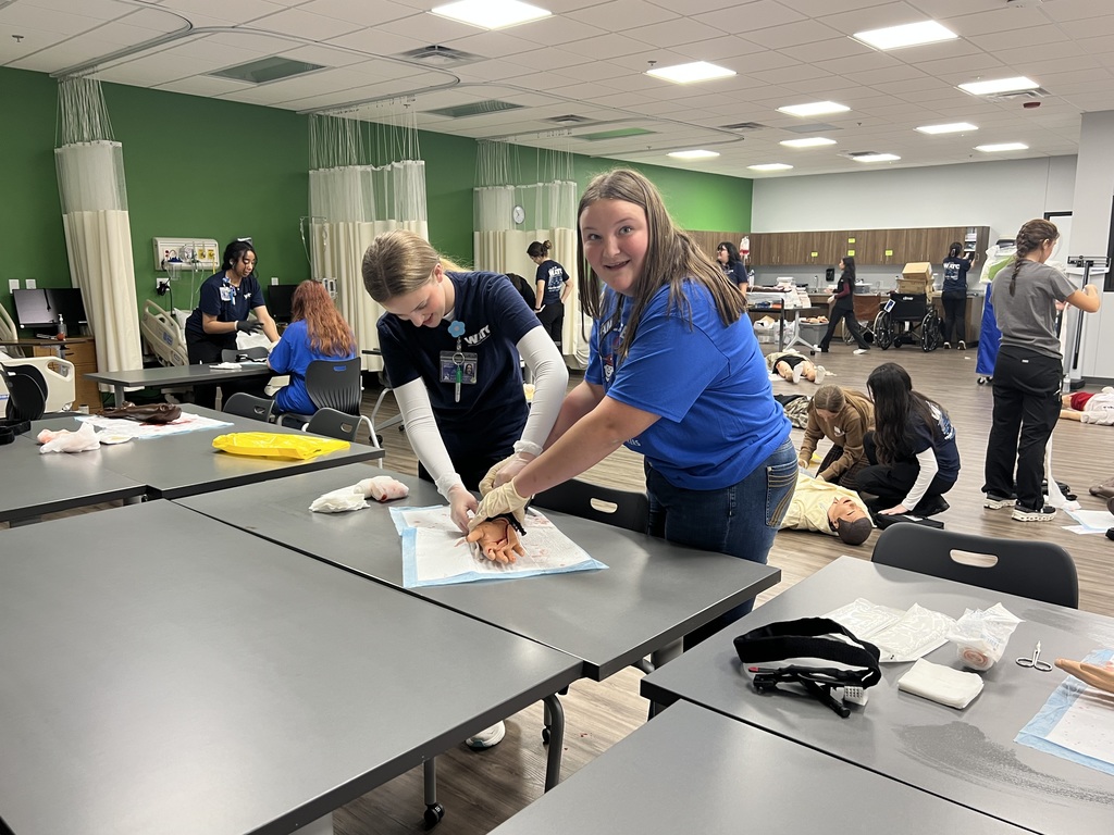 Student learning how to pack a wound