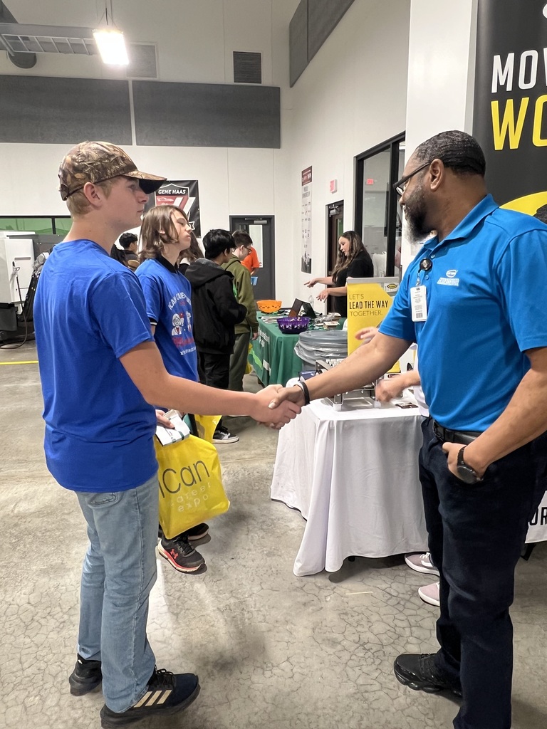 8th grader shaking the hand of a professional before learning about their career