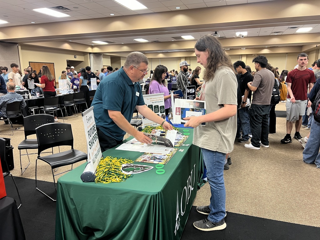 Senior visiting a table at the College Fair