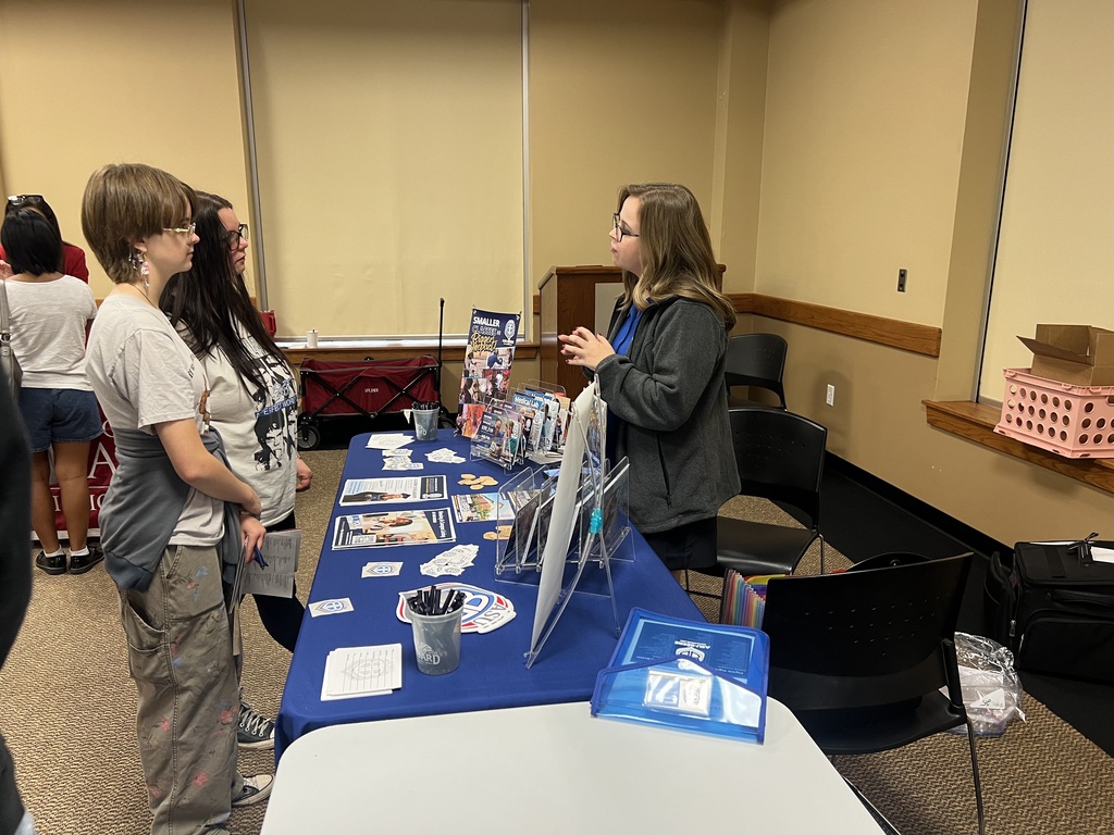 Students visiting with a college at the College Fair