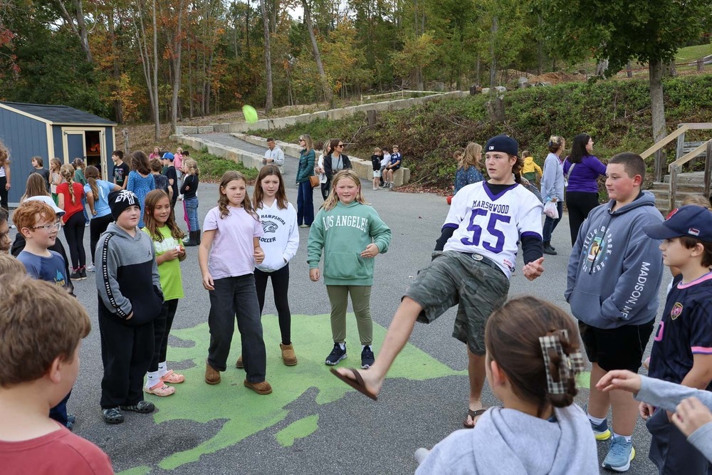 A high school student demonstrates hackey sack skills to students at the Jerry Bernell Great Works School