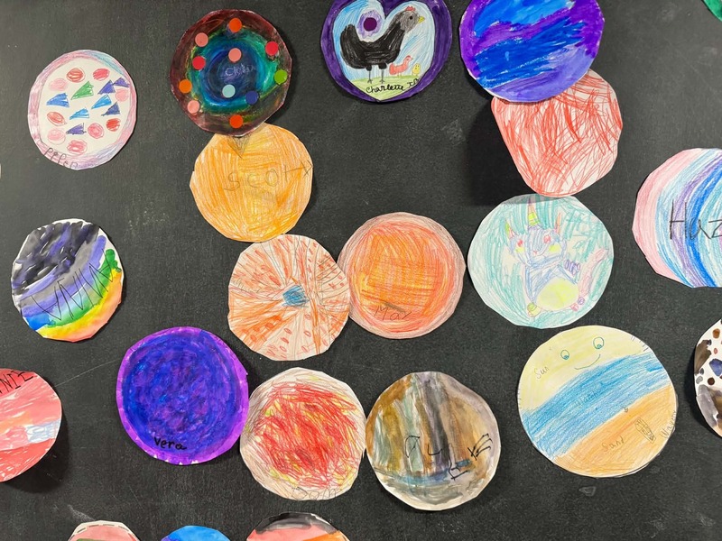 various Dots made by students from Eliot Elementary School hang on the walls in the halls of the school