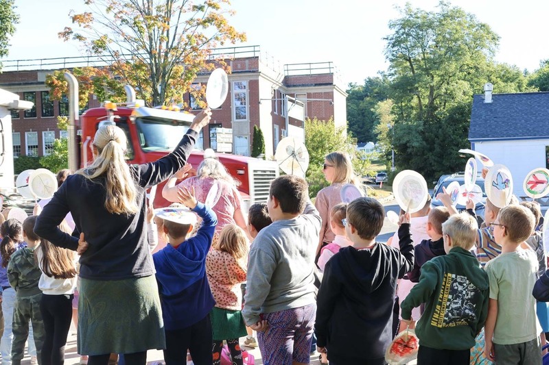 Students from Central School in South Berwick, Maine cheer as a truck honks its horn to join the children in celebration of the International Day of Peace