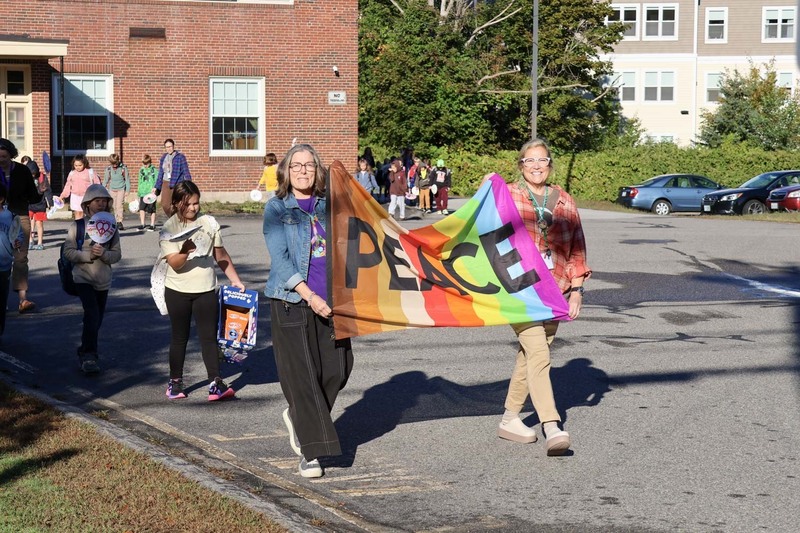 Teachers lead the students at Central School in a parade celebrating the International Day of Peace