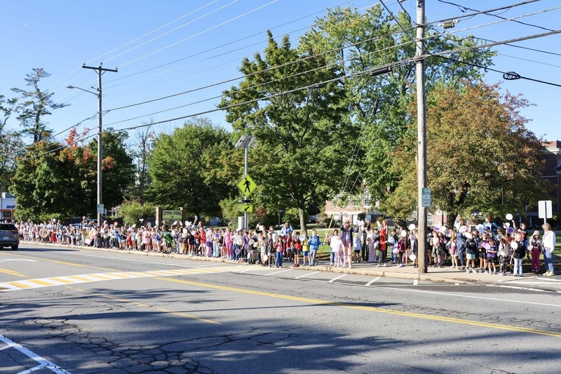 Students gather outside the Central School to celebrate the International Day of Peace by holding a brief parade before the school day.