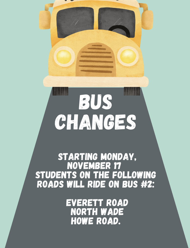 A yellow school bus with a notice on the gray road in front of it about a change.