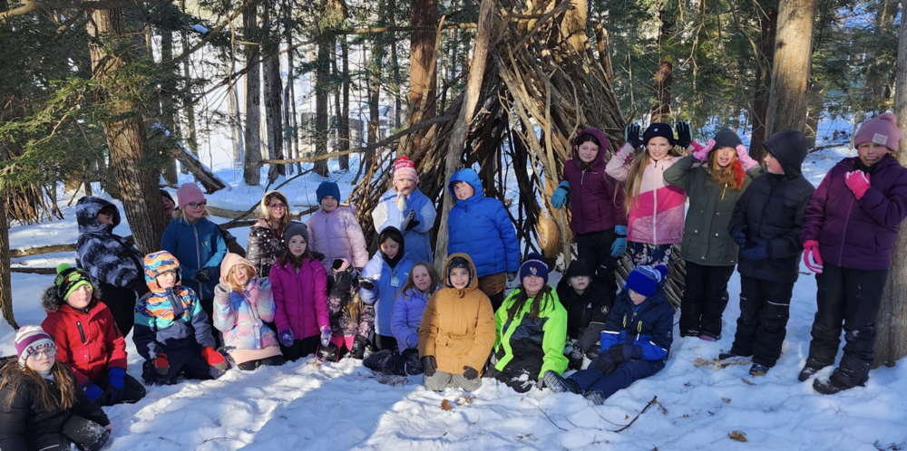 students exploring the woods in winter