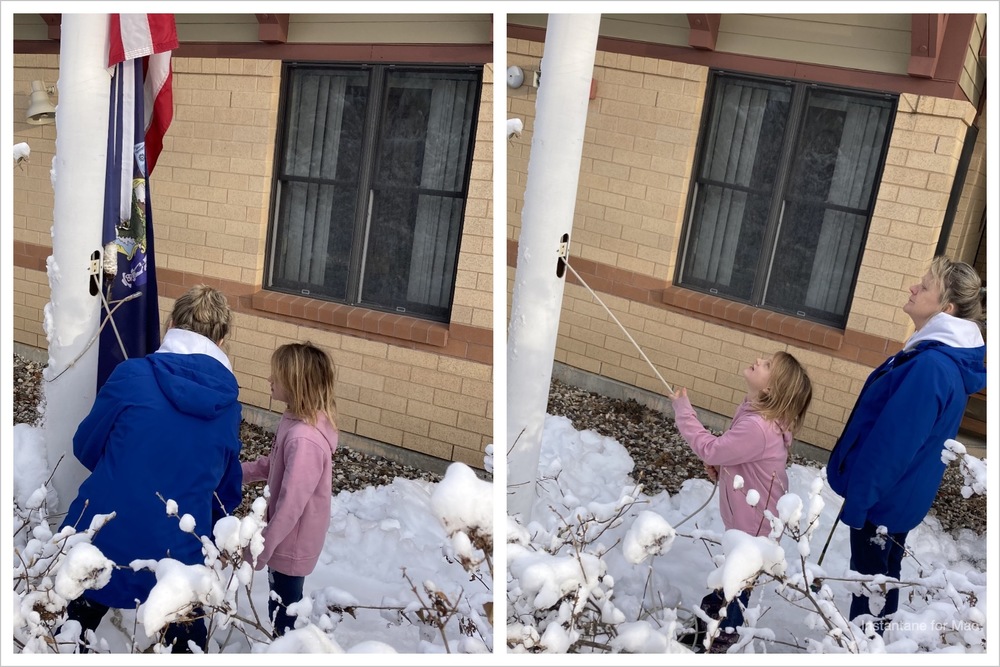 image of a child raising the flag outside