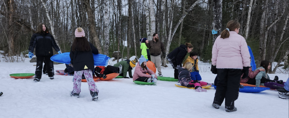 Families sledding at school