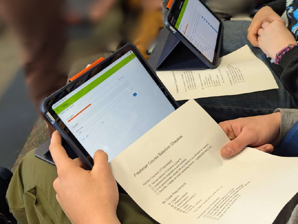 iPad and piece of paper with course registration steps on it