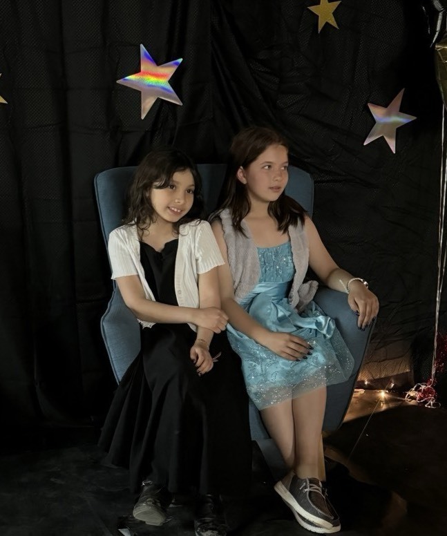 two students sitting on a char together