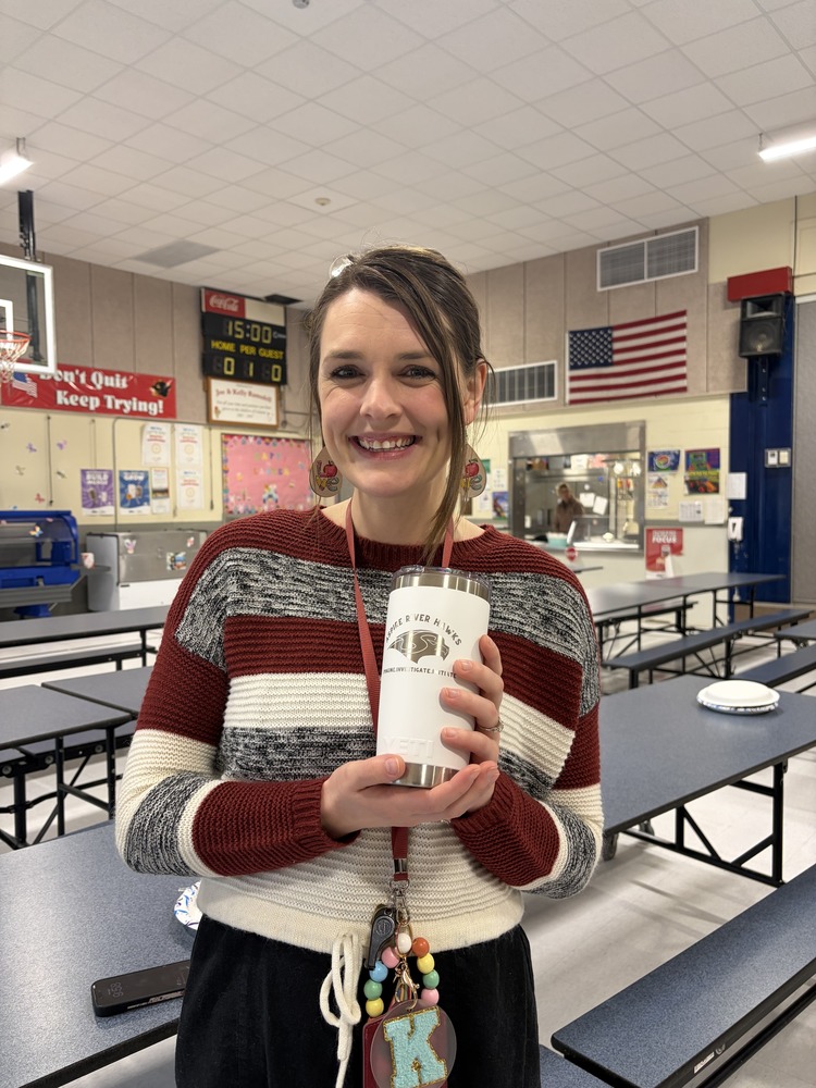 teacher holding cup in school cafeteria