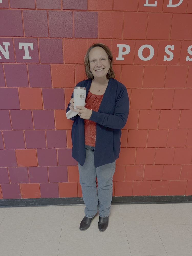 guidance counselor holding  cup in hallway